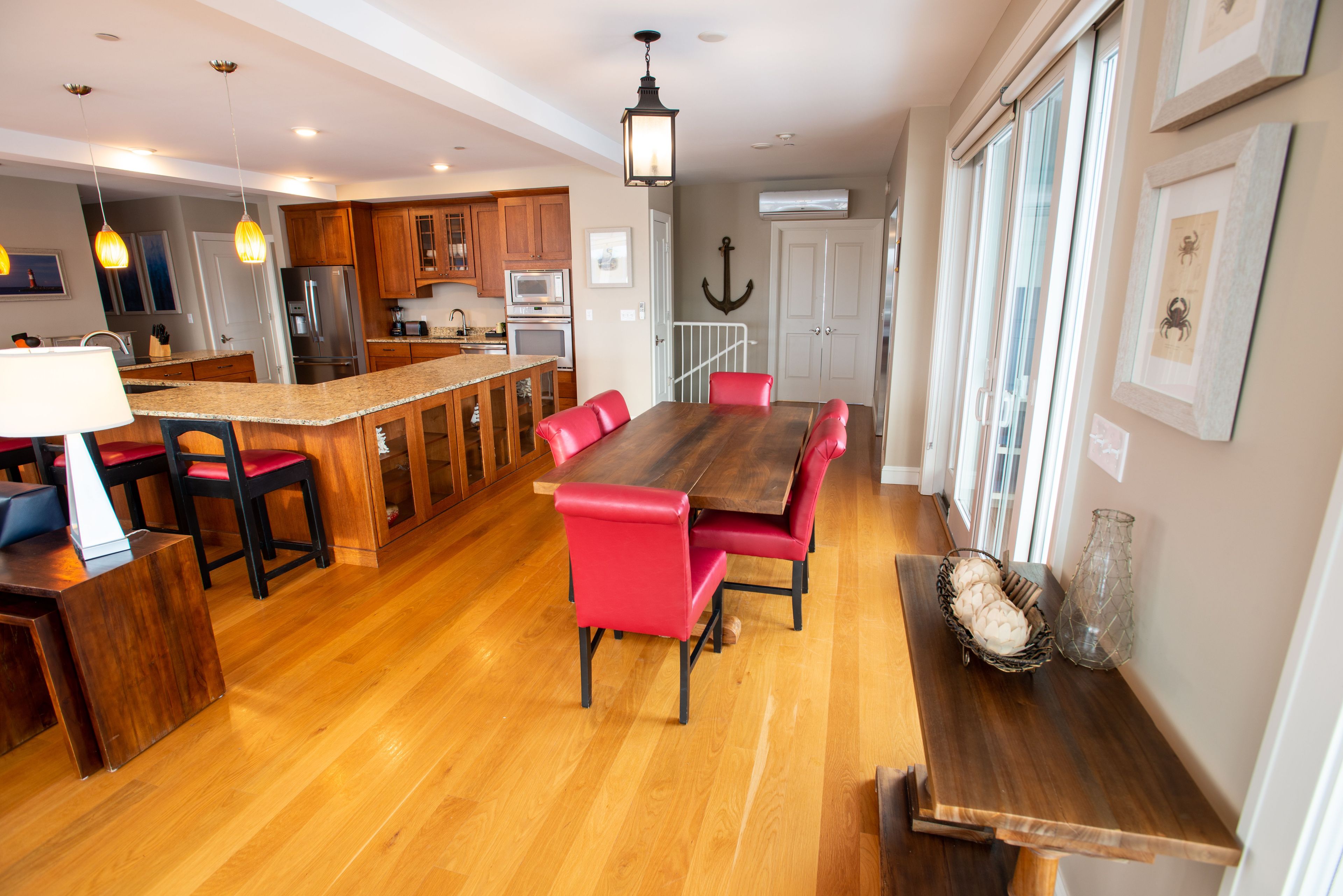 A spacious kitchen with wooden cabinets, a central island, and modern appliances.
