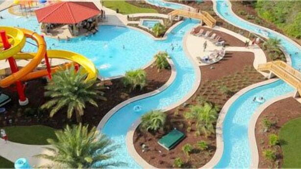 A water park with winding water slides, a pool area, and a covered pavilion.