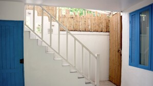 A staircase with white railings leading to a wooden fence. - Costa Village Pool Villa (Pattaya)