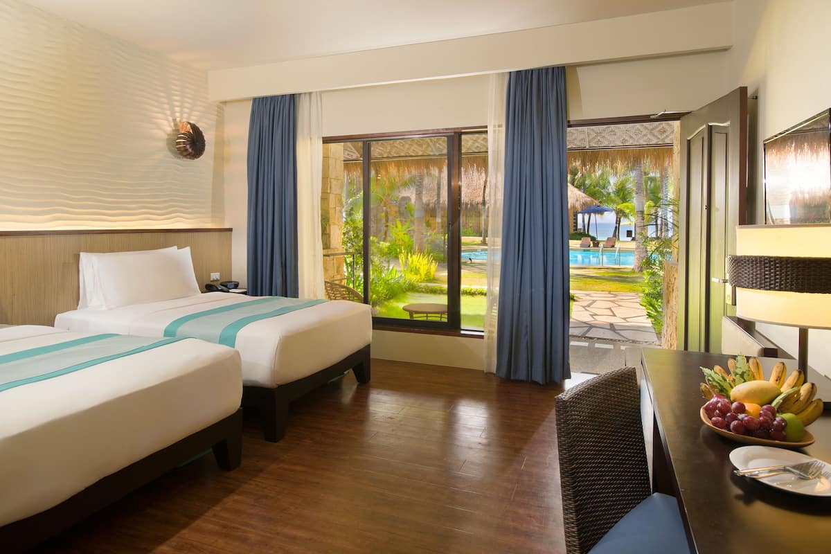 deluxe double or twin room with pool view  | minibar, in-room safe, desk, laptop workspace