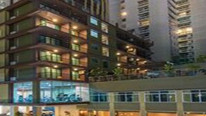 A multi-story hotel with a modern design, featuring balconies and large windows. - Dynasty Grande Hotel (Bangkok)