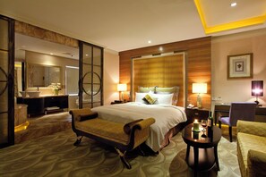 A hotel room with a bed, a desk, a chair, a sofa, a table with a candle, and a mirror. - Alper Motel (Taipei)