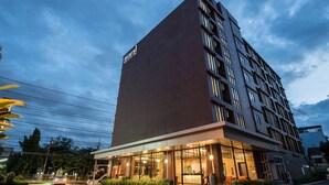 A modern hotel building with a prominent 'marriott' sign, multiple floors, and a well-lit ground floor entrance. - Marsi Hotel (Bangkok)