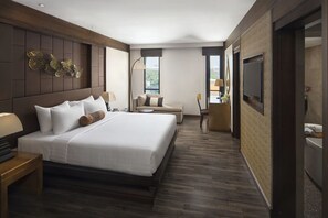 A modern hotel room with a large bed, a sofa, a desk, and a TV. - Casa Nithra Bangkok (Bangkok)