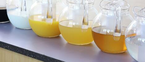 Several glass containers with spouts on a countertop.