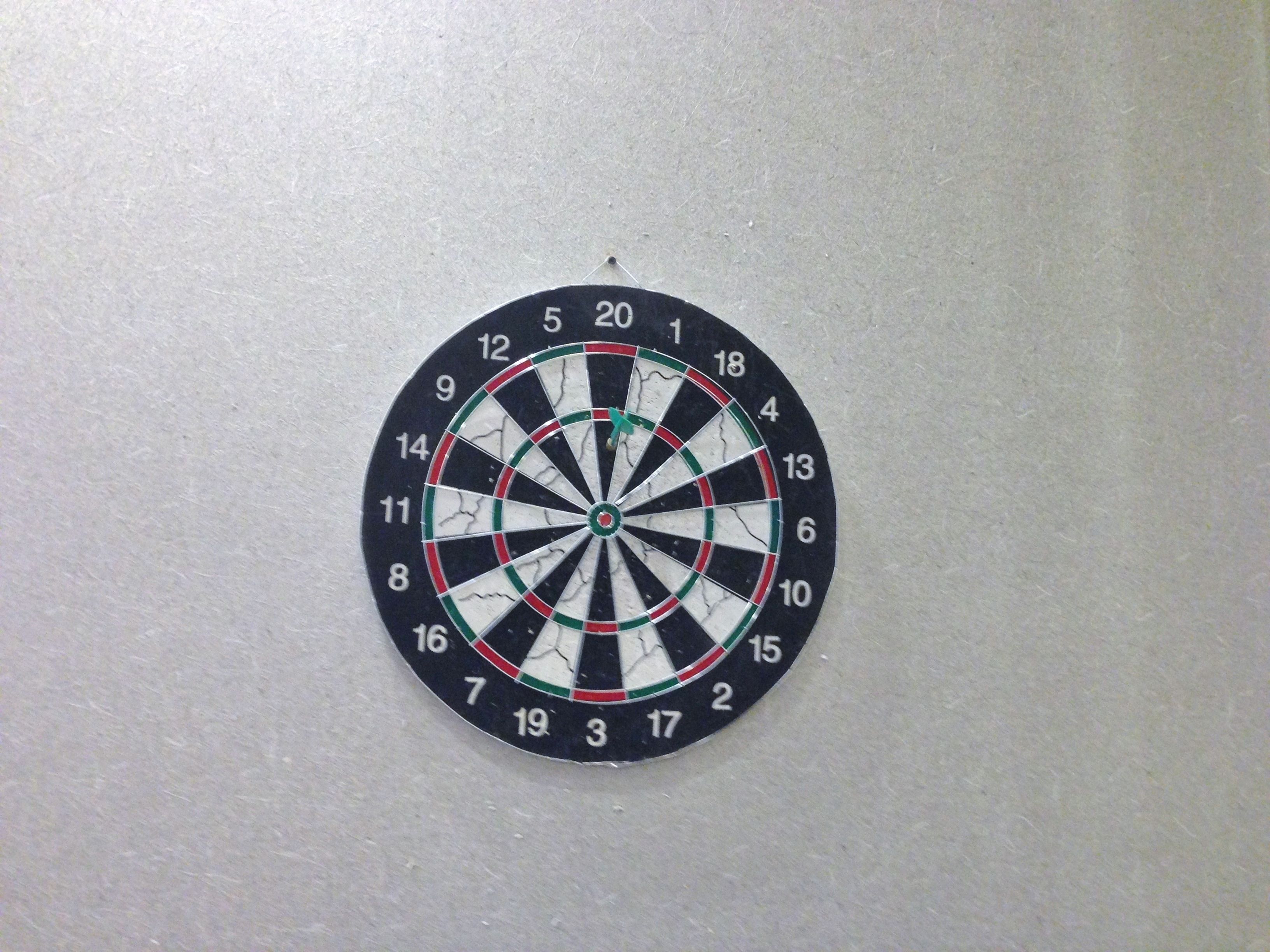 Une cible de fléchettes fixée au mur.