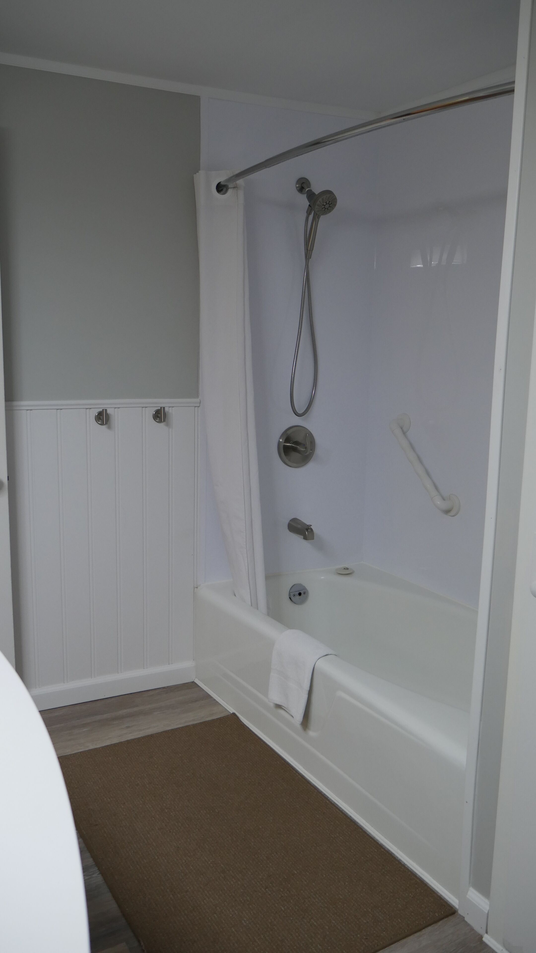 A bathroom with a bathtub, a shower, and a toilet.