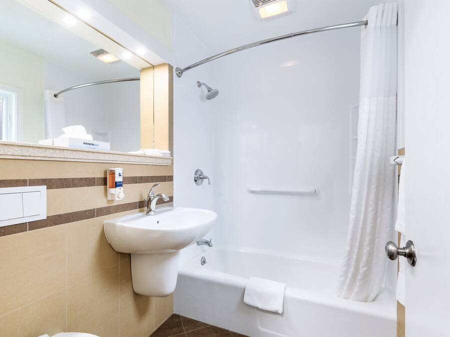 A modern bathroom with a sink, bathtub, and shower.