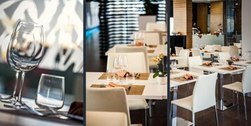 Un interno ristorante moderno con tavoli e sedie bianche, ordinatamente apparecchiati con bicchieri da vino e posate.