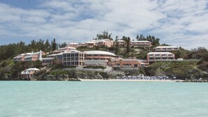 A coastal resort with multiple buildings, a beach, and clear turquoise waters. - Pompano Beach Club (Southampton Parish)