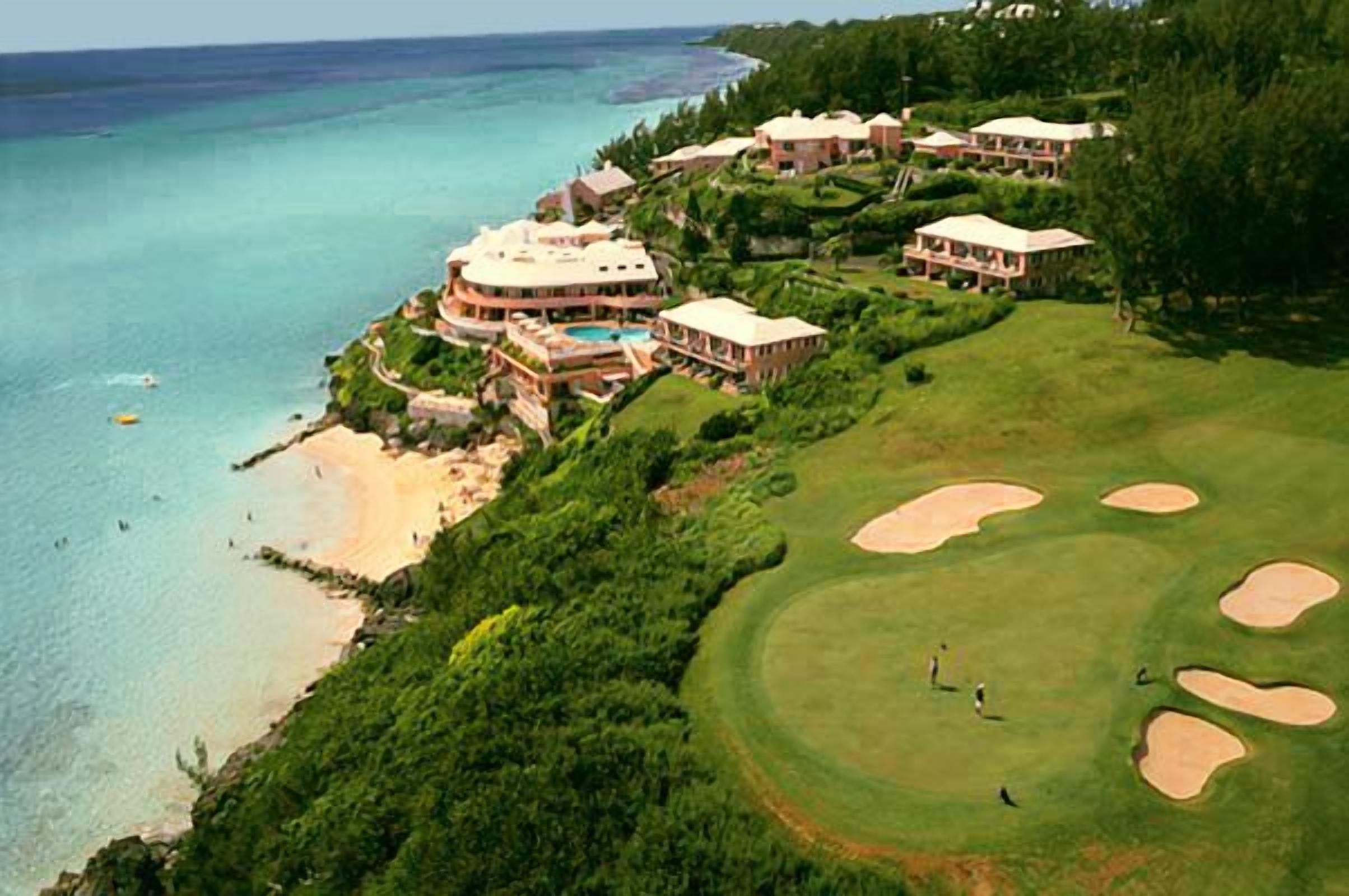A golf course with bunkers, a pool, and a beach area.