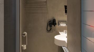 Une salle de bain moderne équipée d’une douche, de toilettes et d’un lavabo.