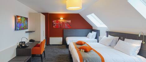 A hotel room with two beds, a desk, and a chair. There is a painting on the wall and a skylight above the beds.