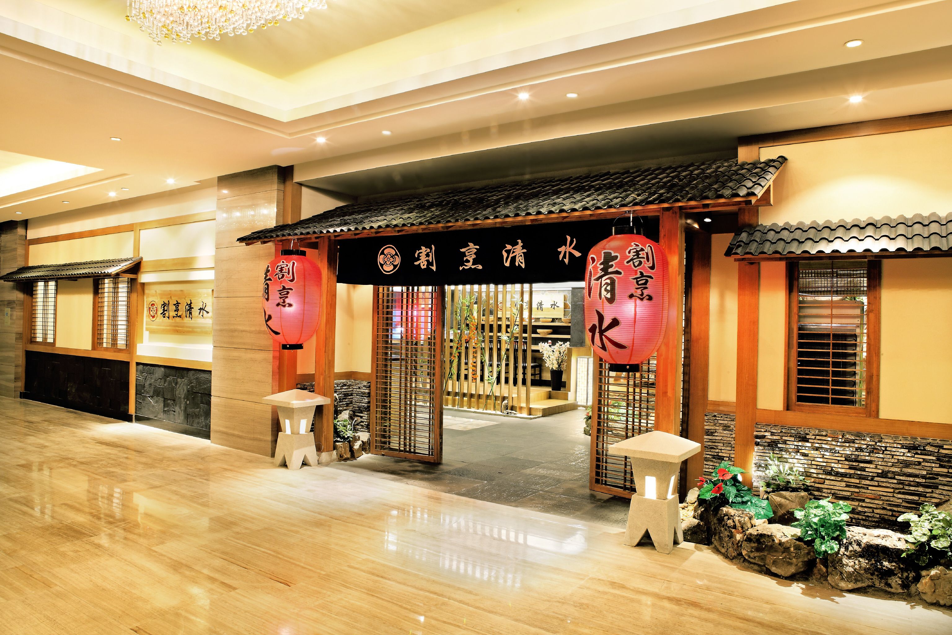 A traditional Japanese-style entrance with a tiled roof, wooden pillars, and a stone pathway leading inside.