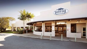 A modern building with a sign reading "BARRA BAR" and "AT THE SPRINGWOOD HOTEL".