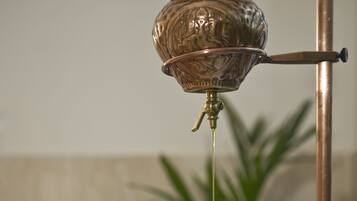 A person receiving a head massage with a metallic head massager.