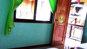 A room with a bed, a window with curtains, a door, and a view of the outside. - Boracay Actopia Resort (Boracay Island)