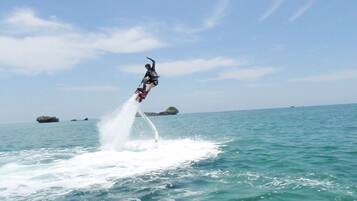 A person performing a water-based stunt on a jet ski.