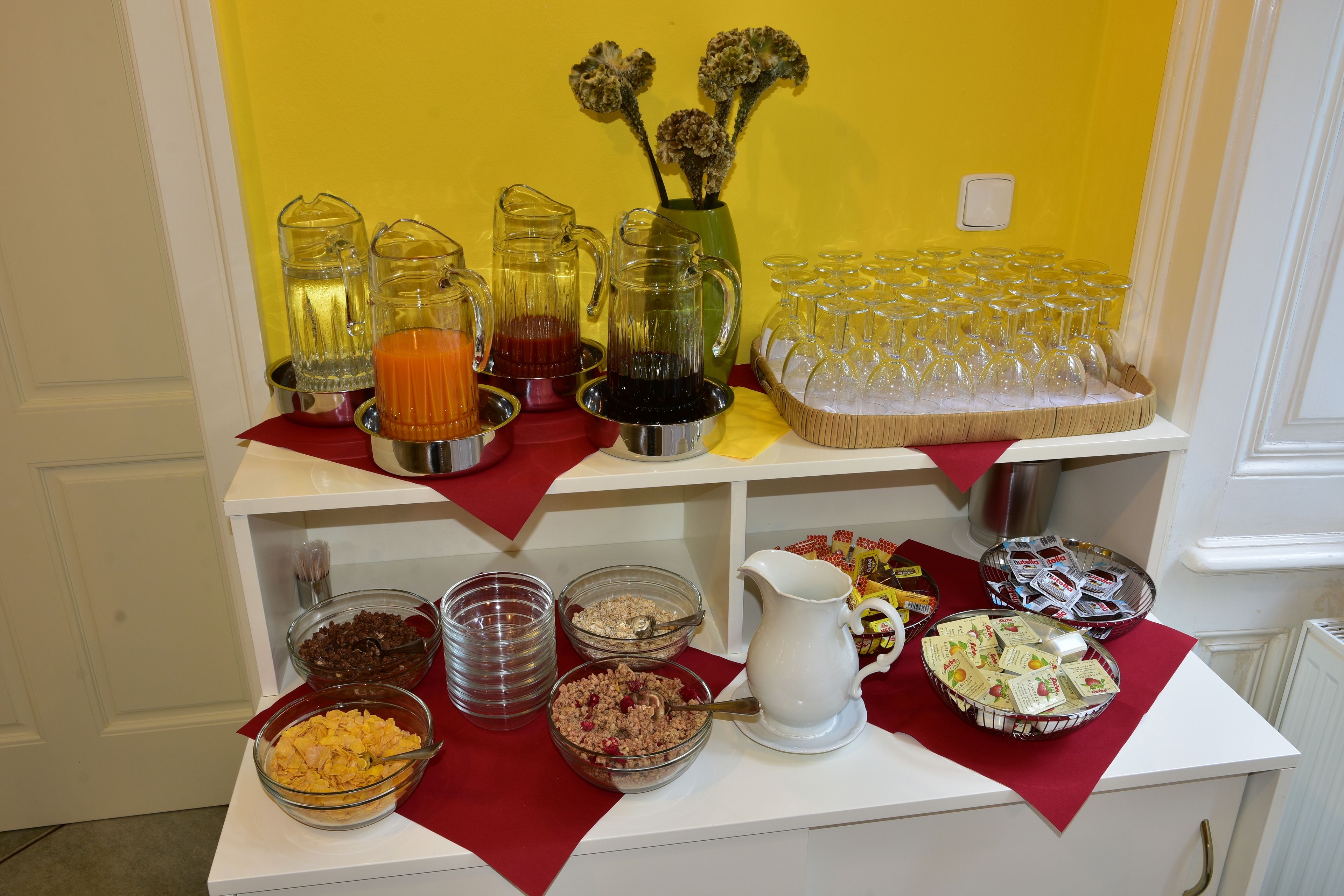 A buffet table with various food items and drinks.
