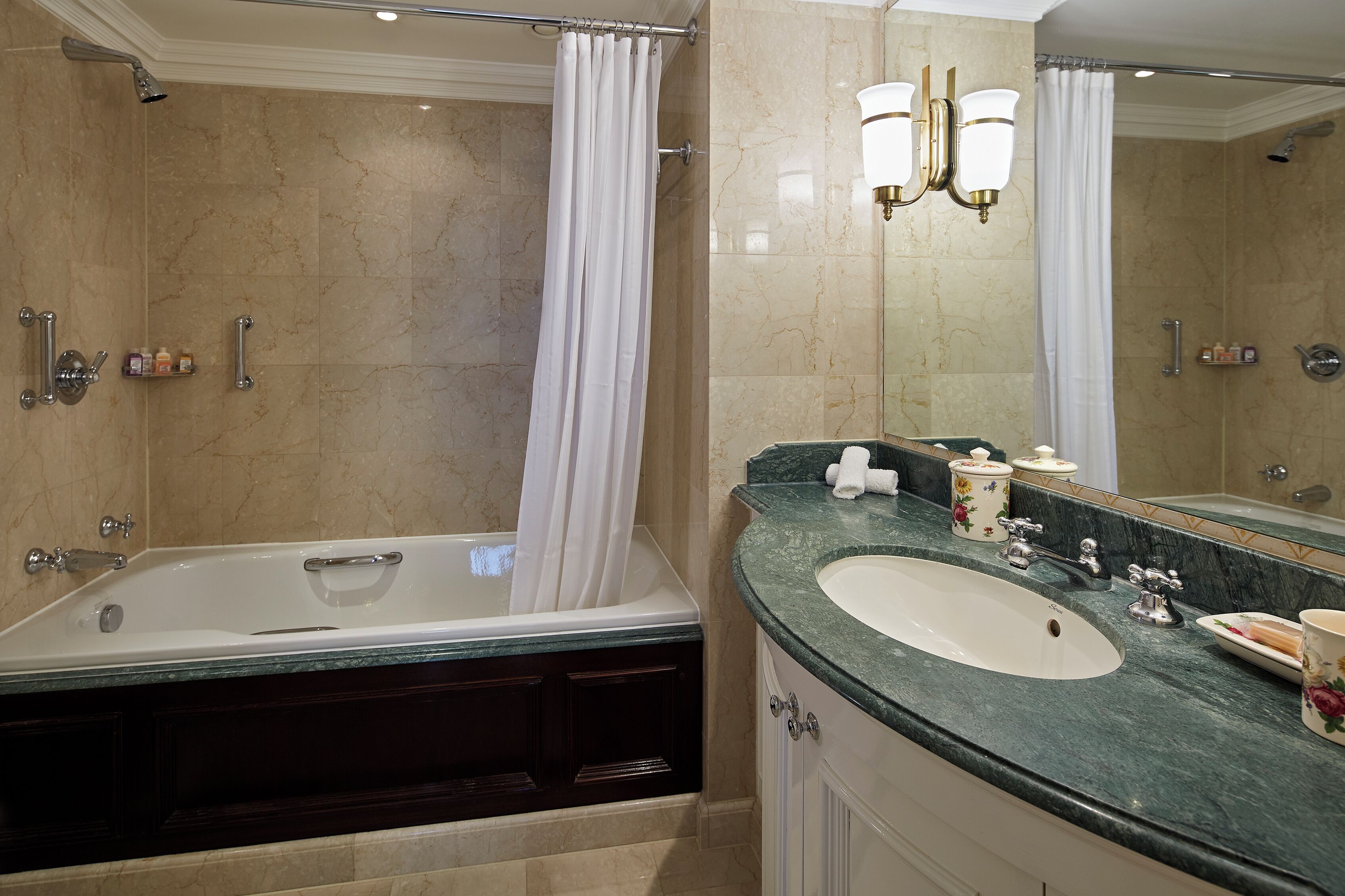 A bathroom with a bathtub, a sink, and a vanity.