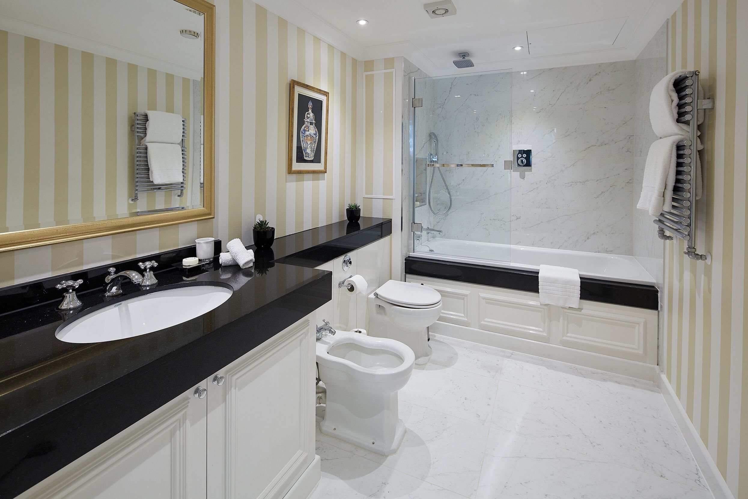 A modern bathroom with a large sink, toilet, and bathtub.