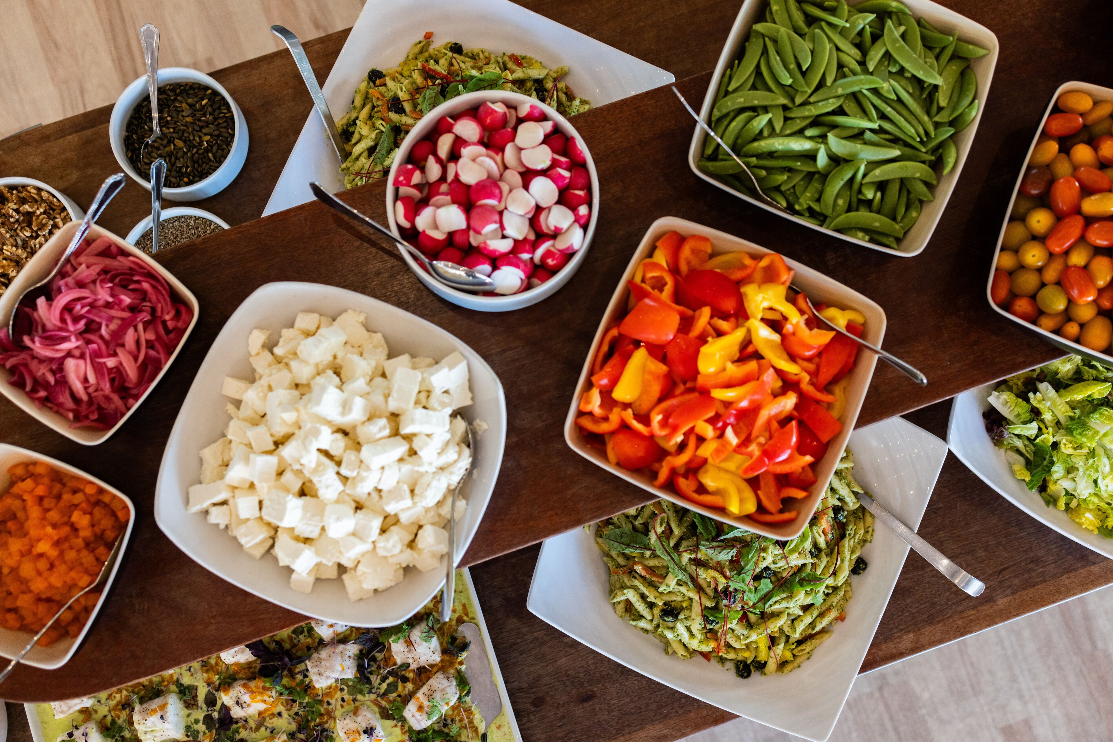 A variety of food items arranged on a wooden table.