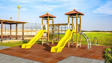 Kids can play on the playground structure with two slides and a playhouse.