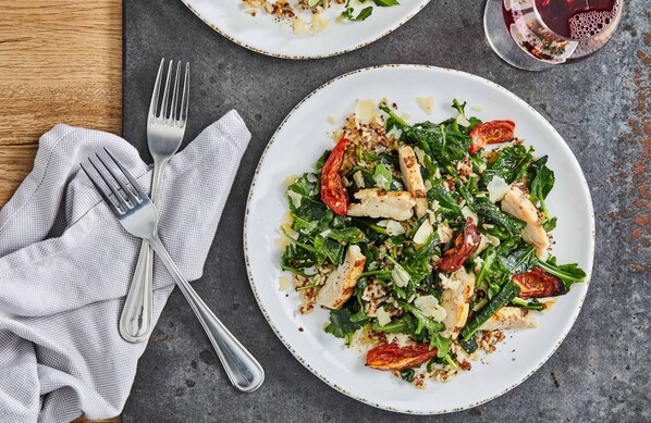 A plate of food with a fork and knife on a table.