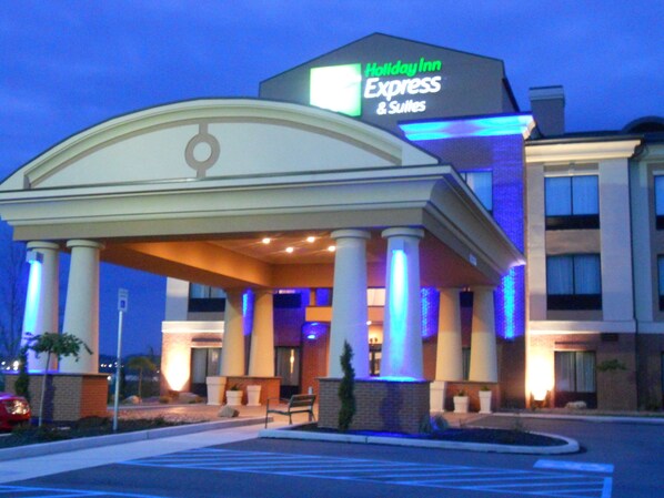 A Holiday Inn Express & Suites building with a covered entrance, columns, and a sign. - Holiday Inn Express & Suites Greensburg by IHG (Greensburg)