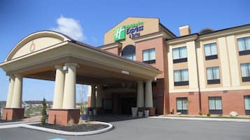 A Holiday Inn Express building with a covered entrance and a parking lot.