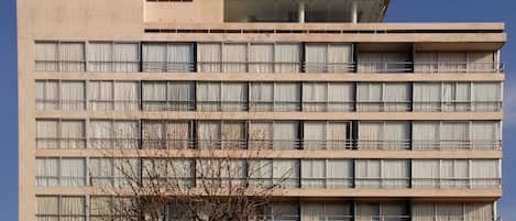 A multi-story building with numerous windows and balconies.