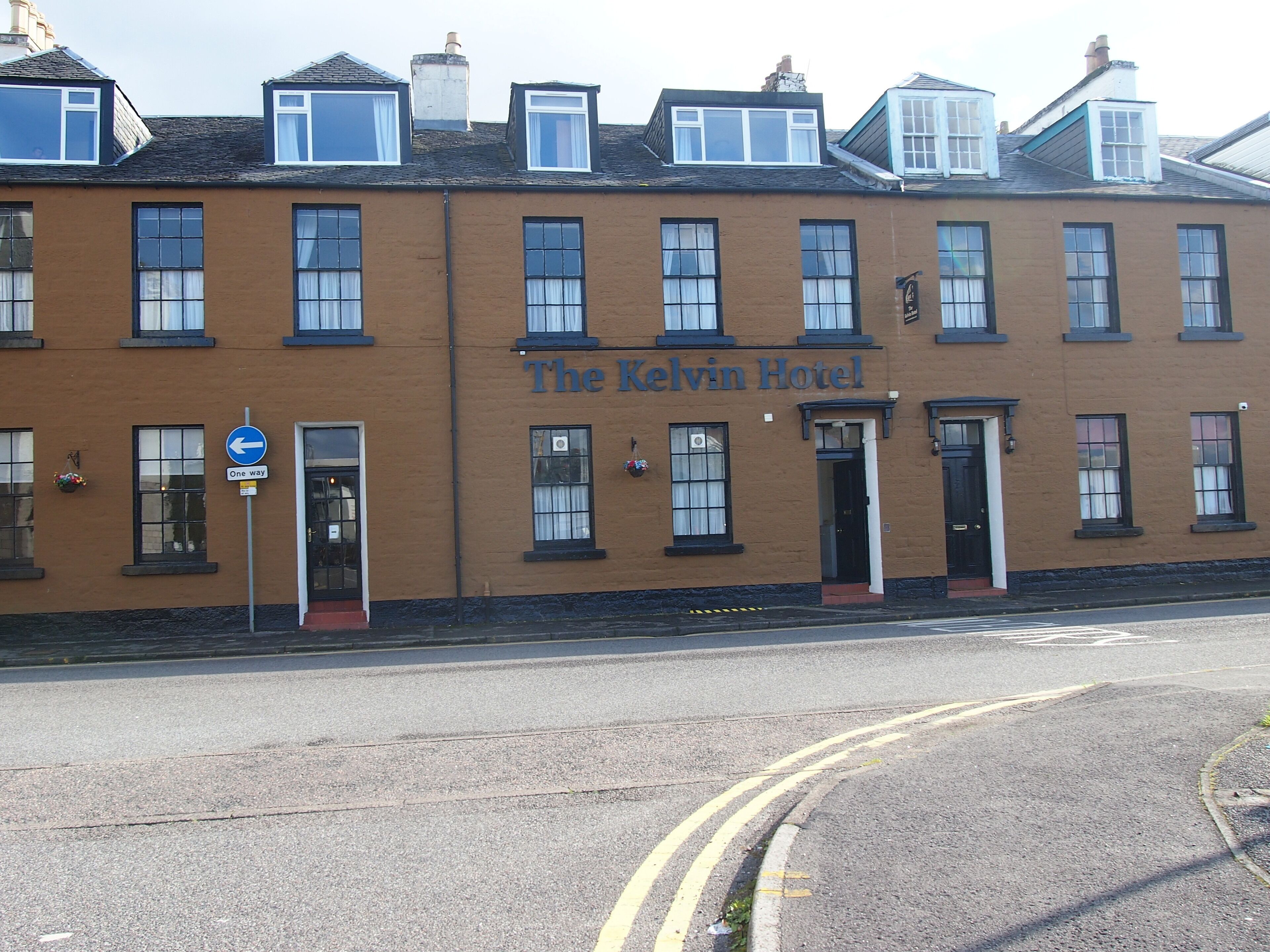 A two-story building with a sign reading "The Kelvin Hotel".