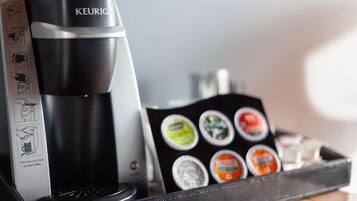 A Keurig coffee maker with a tray of coffee pods.