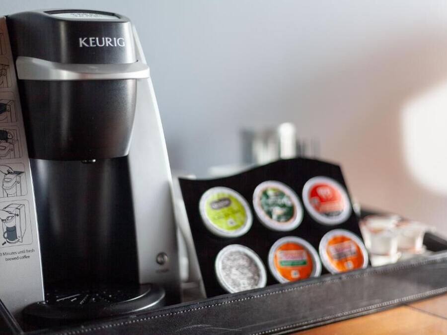 A Keurig coffee maker with a tray of coffee pods.