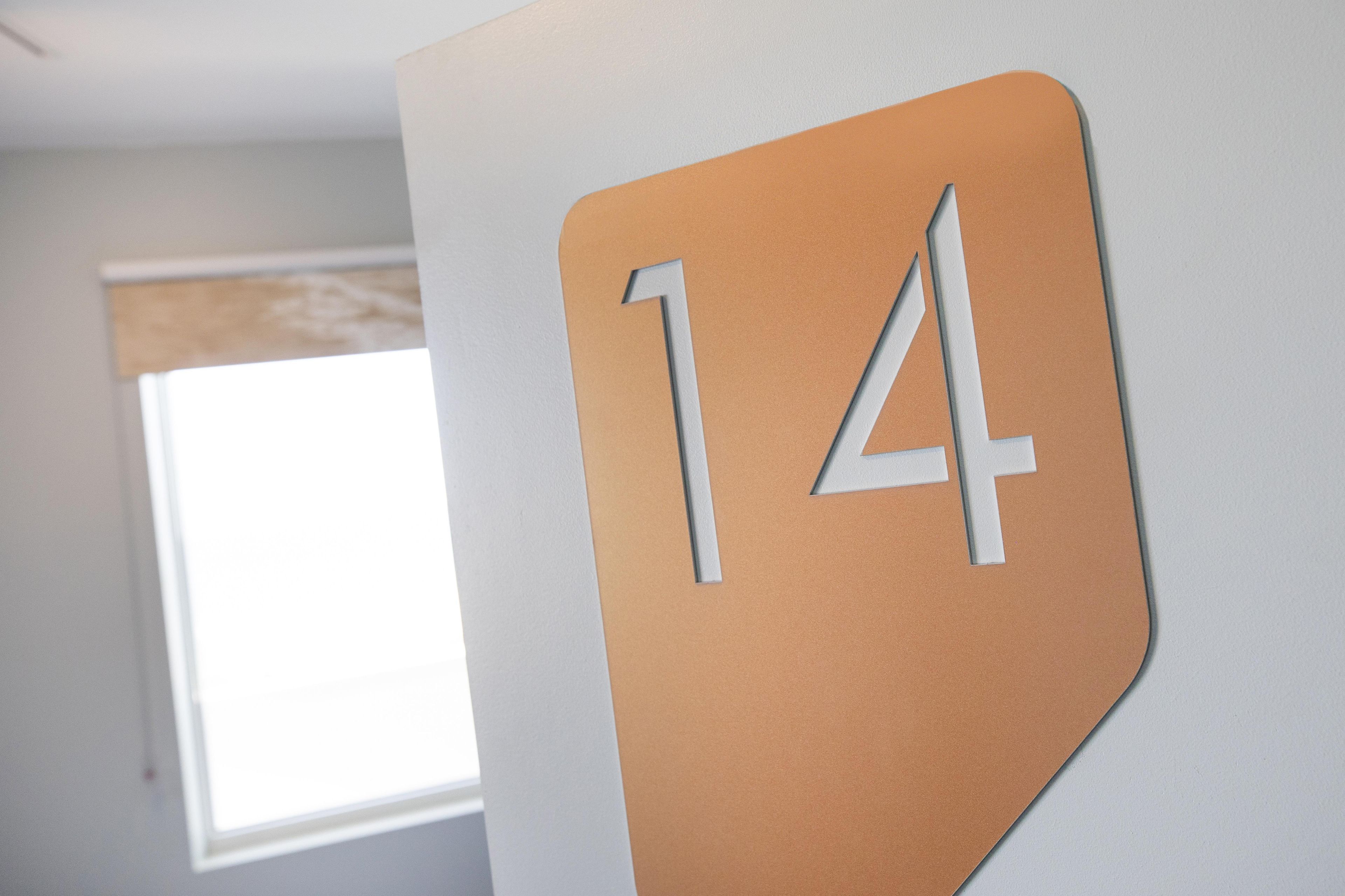 A wall with a large number '14' sign.