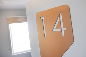 A wall with a large number '14' sign. - Nightcap at Esplanade Hotel (Brighton)
