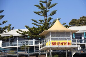 A building with a balcony and a sign that reads 'BRIGHTON'. - Nightcap at Esplanade Hotel (Brighton)
