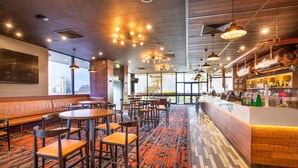 A restaurant with booths, tables, and a bar area. - Nightcap at Sandringham Hotel (Sandringham)