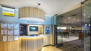 A reception area with a cash-out counter, a reception desk, and a sign indicating the reception.