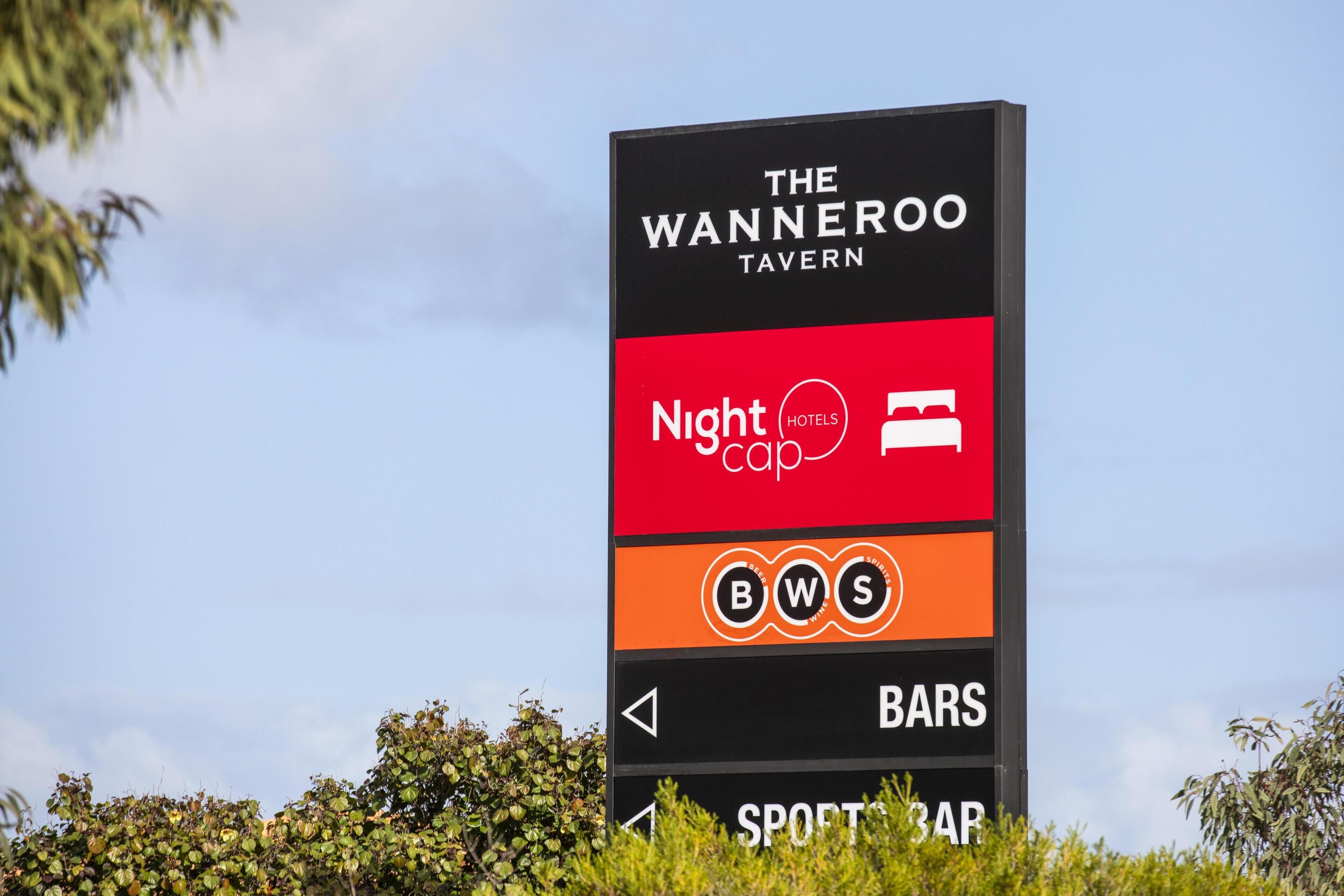 A sign for The Wanneroo Tavern with sections for Nightcap, BWS, Bars, and Sport Bar.
