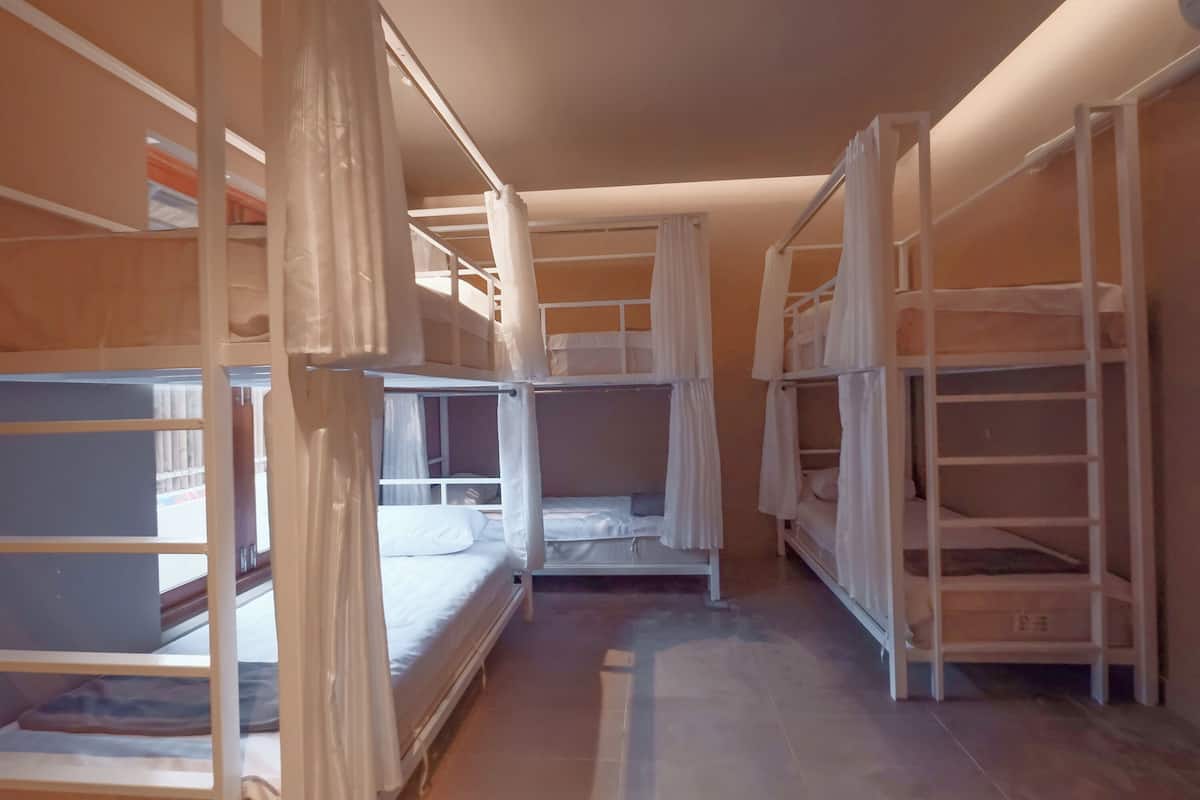 A room with bunk beds and storage shelves.