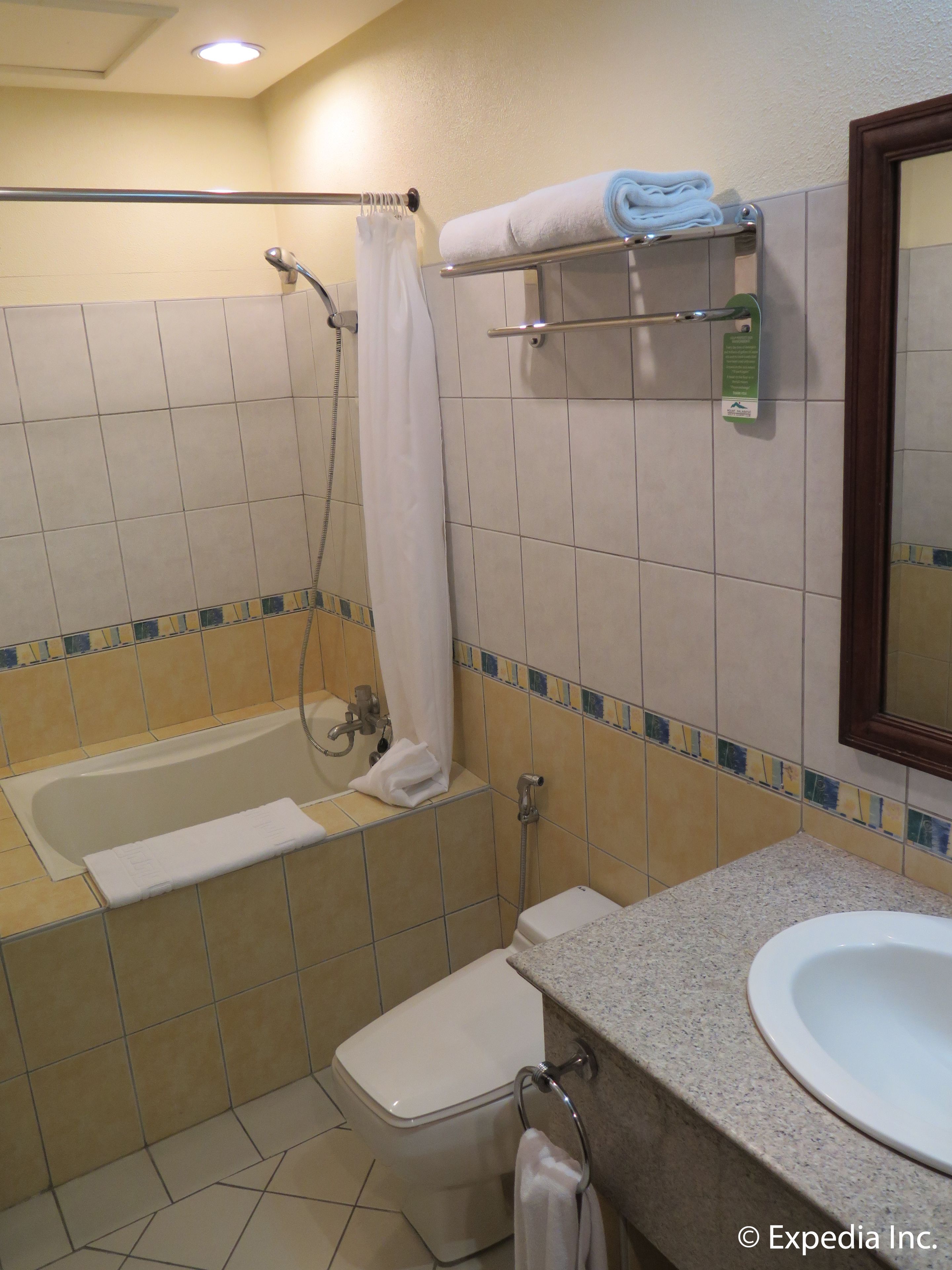 A bathroom with a bathtub, toilet, and sink.
