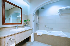 A modern bathroom with a double sink vanity, a large mirror, a bathtub, and a shower. - The Suites at Mount Malarayat (Lipa)