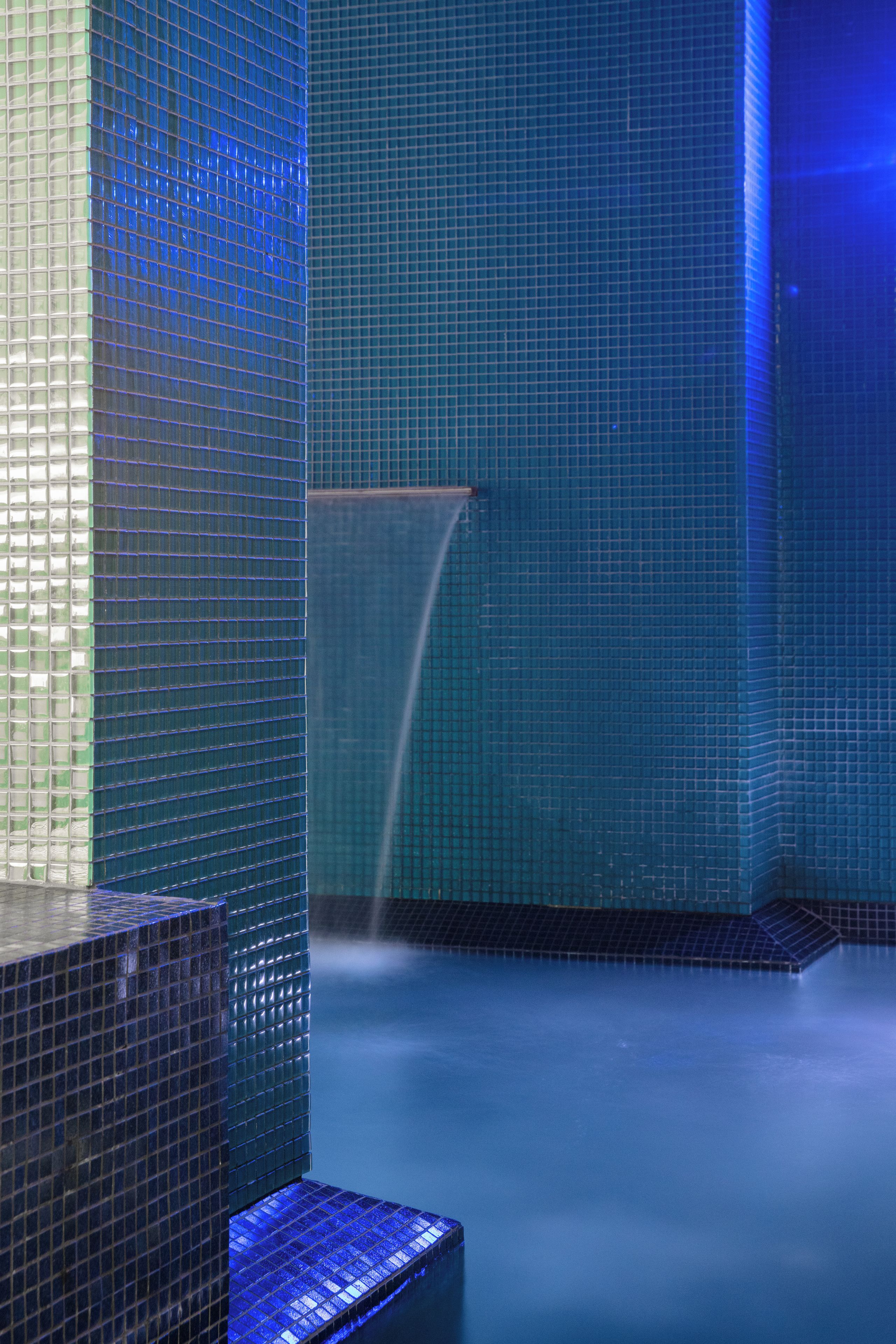 A tiled interior with a water feature.