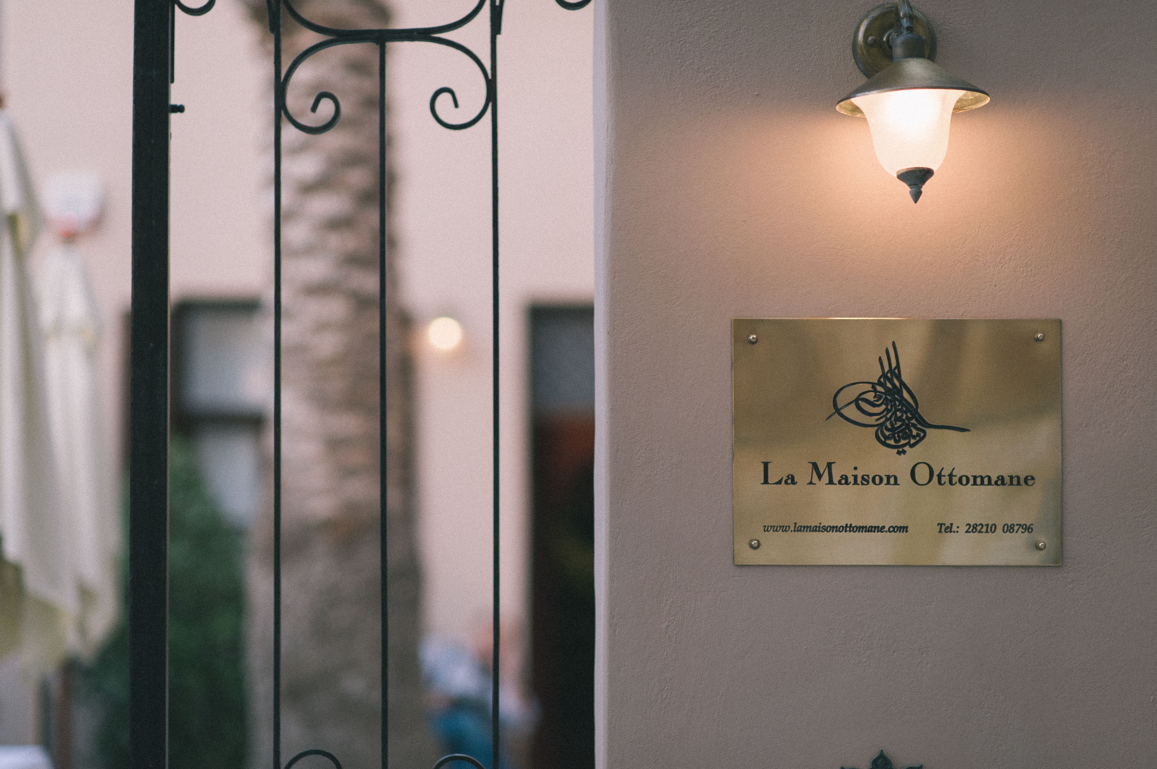 A plaque with the name "La Maison Ottomane" and a website URL.
