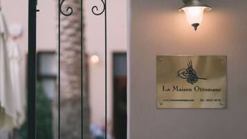 A plaque with the name "La Maison Ottomane" and a website URL.