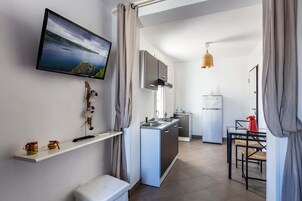 Suite Junior | Area soggiorno | TV a schermo piatto
