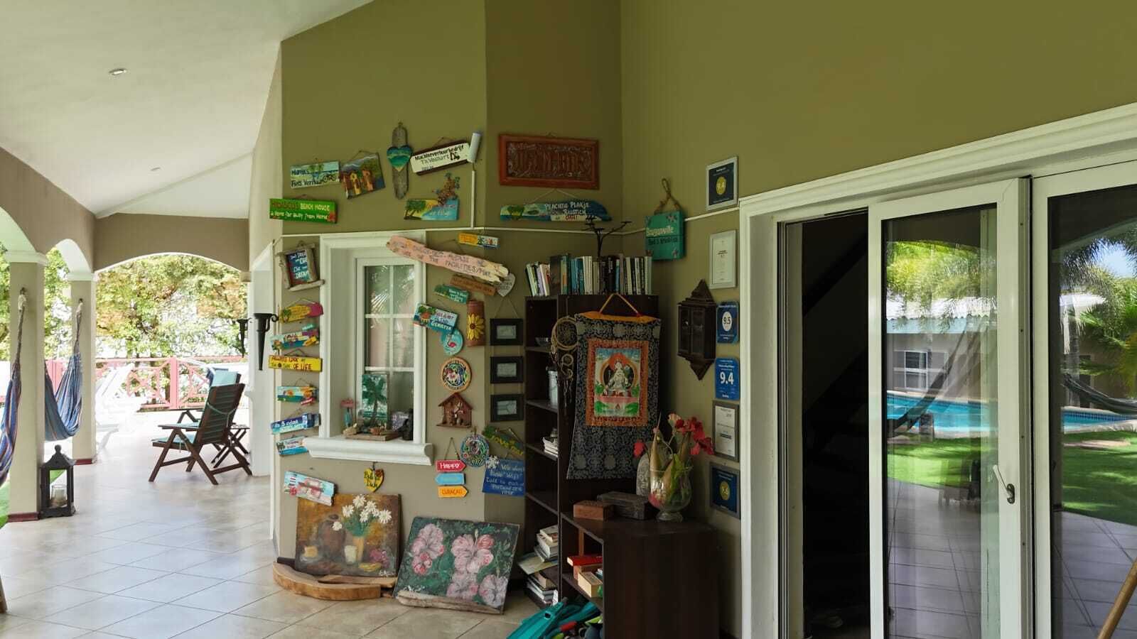 Una habitación con un patio, una ventana con adornos varios y vistas a una piscina.
