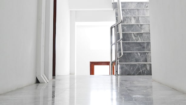 A modern, minimalist interior with a polished marble staircase and a clean, white color scheme. - Highfive Guest House (Pattaya)