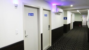 A hotel corridor with doors labeled 1056, 1057, and 1058. - LIHO Hotel - Tainan (Tainan)
